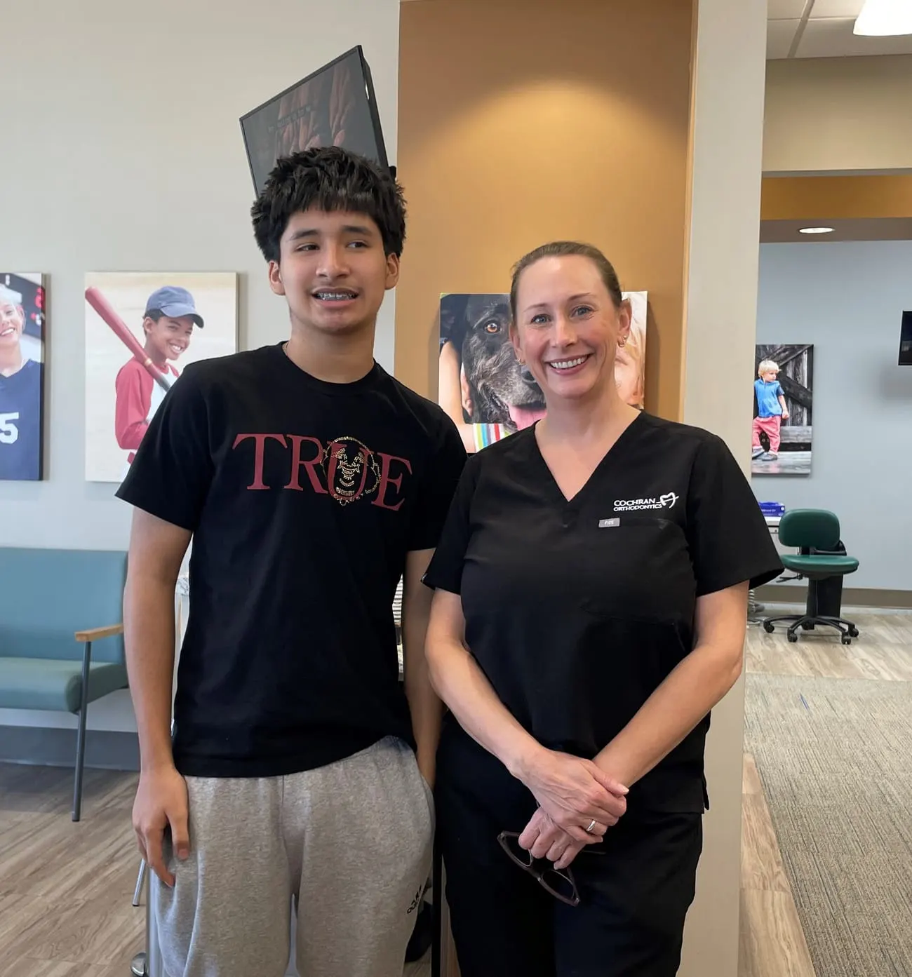 A Cochran Orthodontics patient with a team member at the front desk