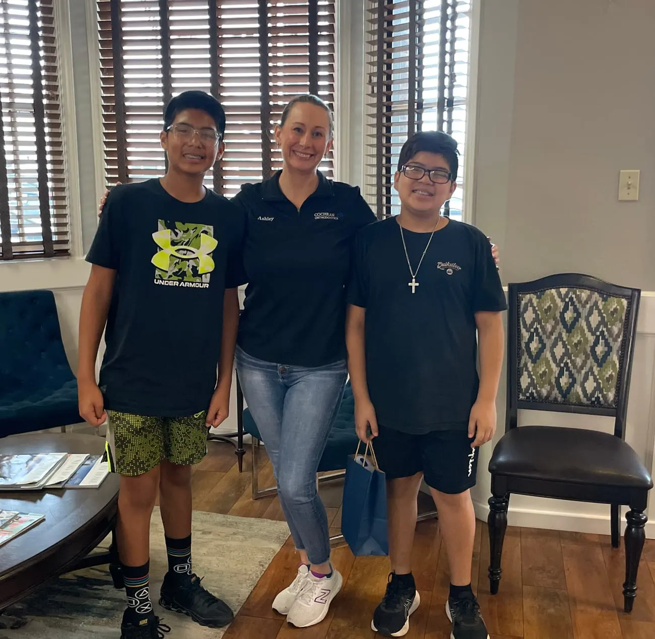 Cochran Orthodontics patients with a team member in the Blanco Rd waiting area